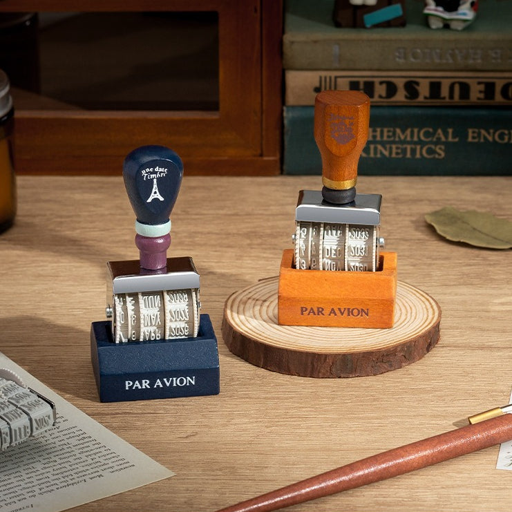 Vintage date roller stamp with wood-style handle, retro postal lettering, metal date wheels, and desk display base