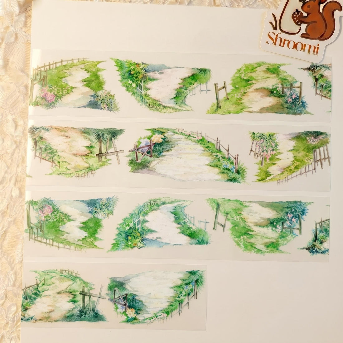 Watercolor PET tape artwork with countryside paths, open fields, fences, grass, and soft rural scenery