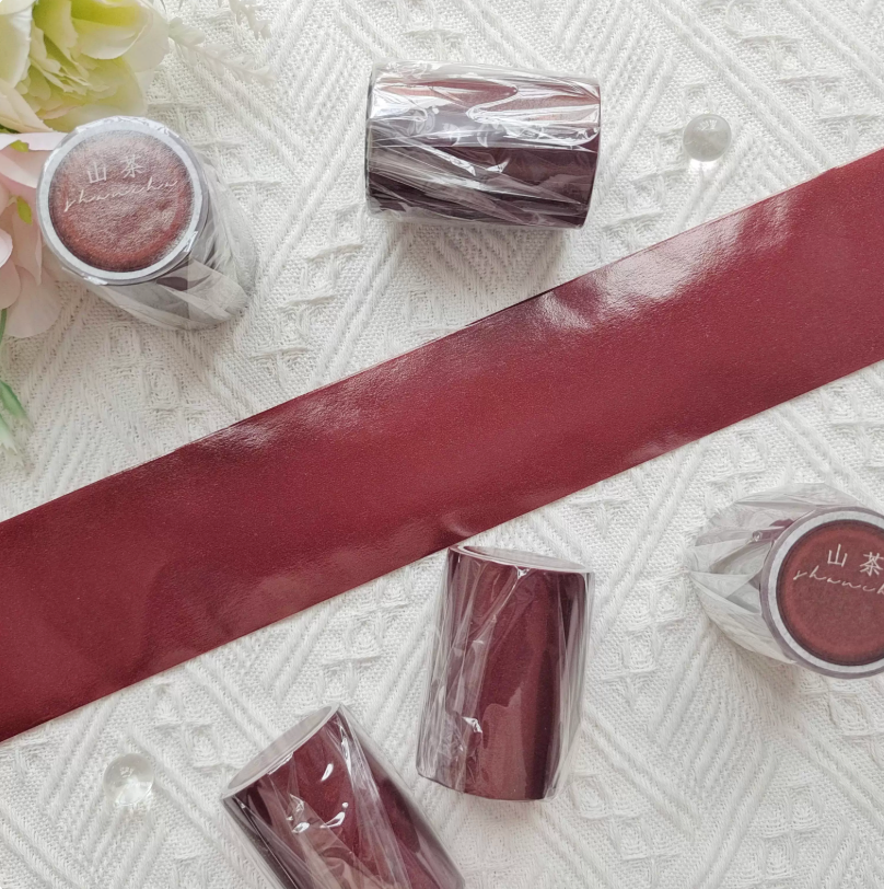 Solid color wide background washi tape in deep burgundy red — unrolled strip showing flat color