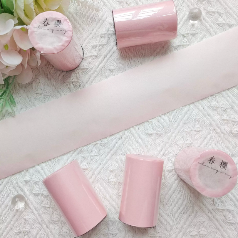 Solid burgundy washi tape roll side view showing tape width and core