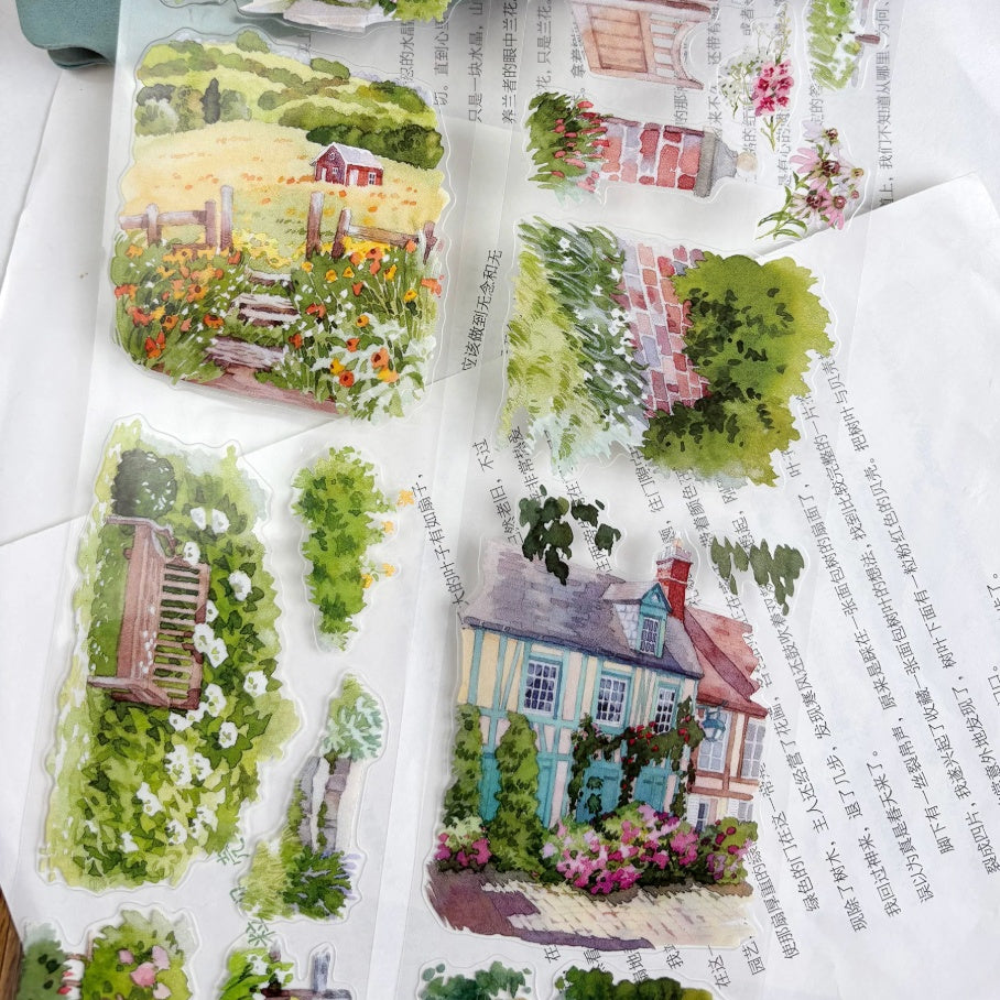 English cottage garden PET die-cut washi tape showing watercolor garden scenes with brick cottage, blue door, and lush green hedges