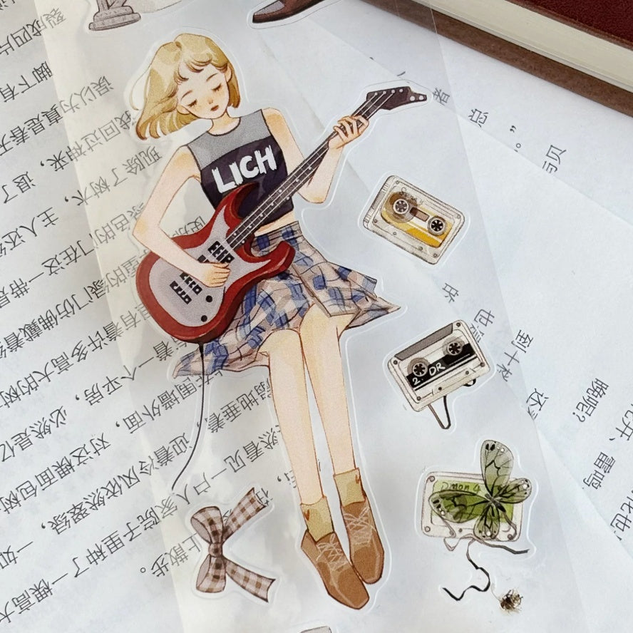 Musician characters washi tape roll showing die-cut illustrated figures on clear PET base