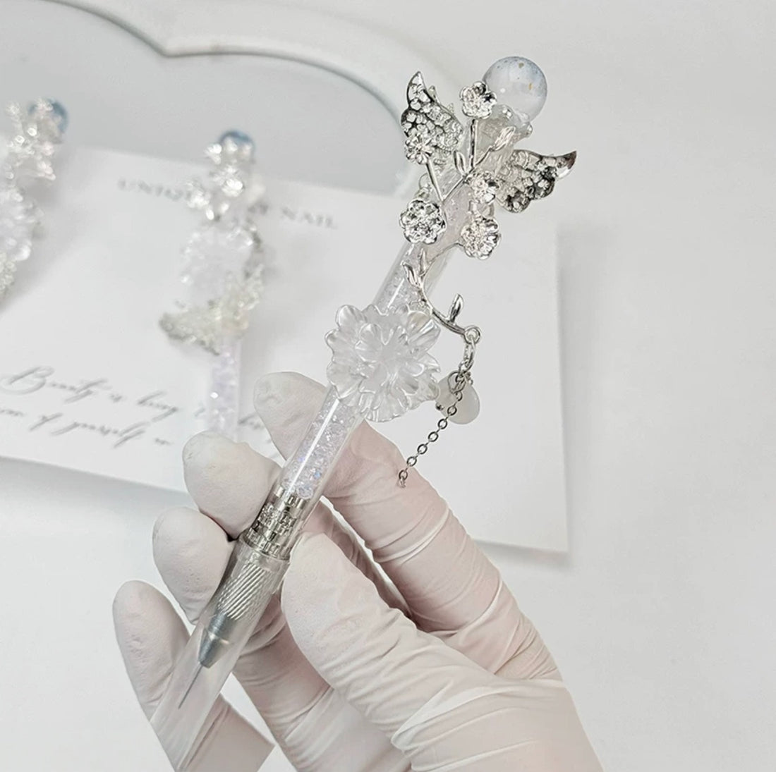 Celestial butterfly decorative craft knife with moon, sun, rose, and chain charms