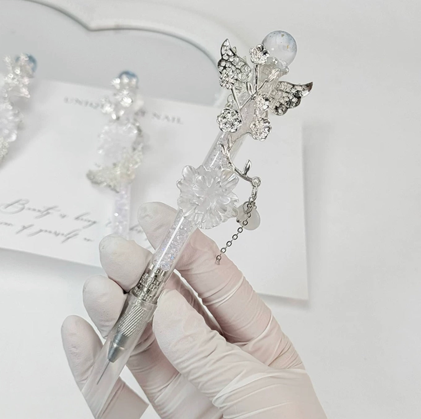Celestial butterfly decorative craft knife with moon, sun, rose, and chain charms