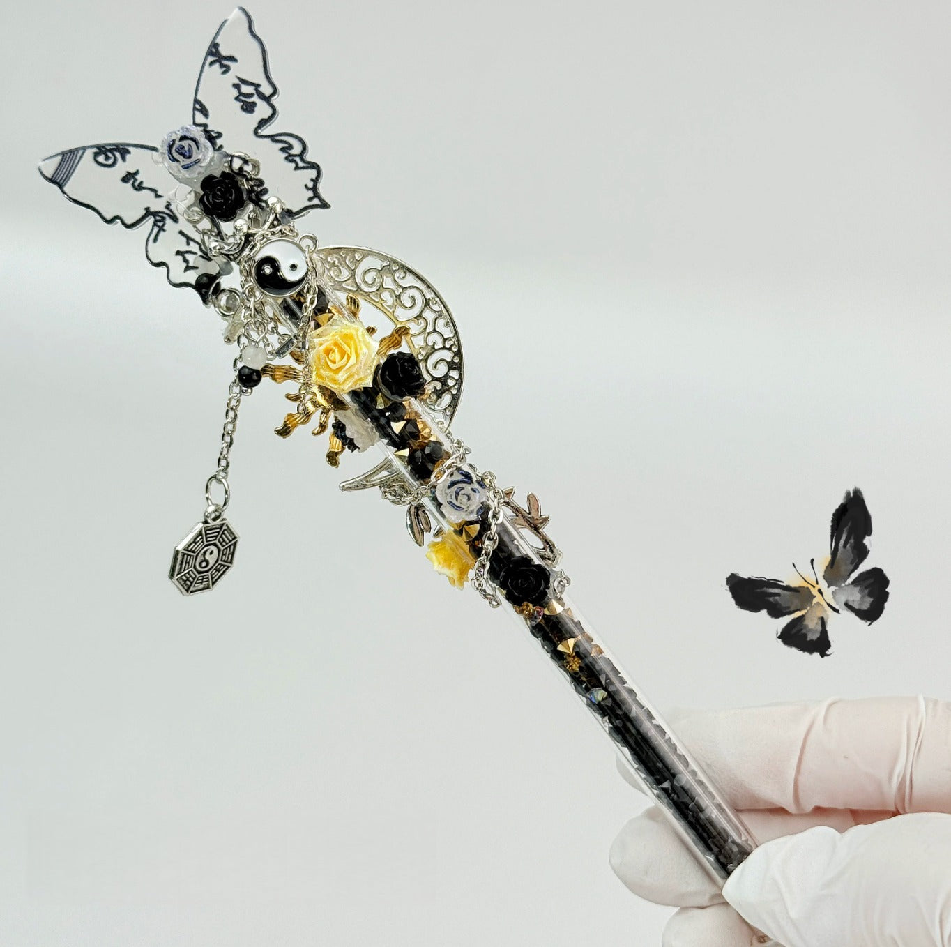 Vintage silver floral craft knife with wing and charm details in a metal case