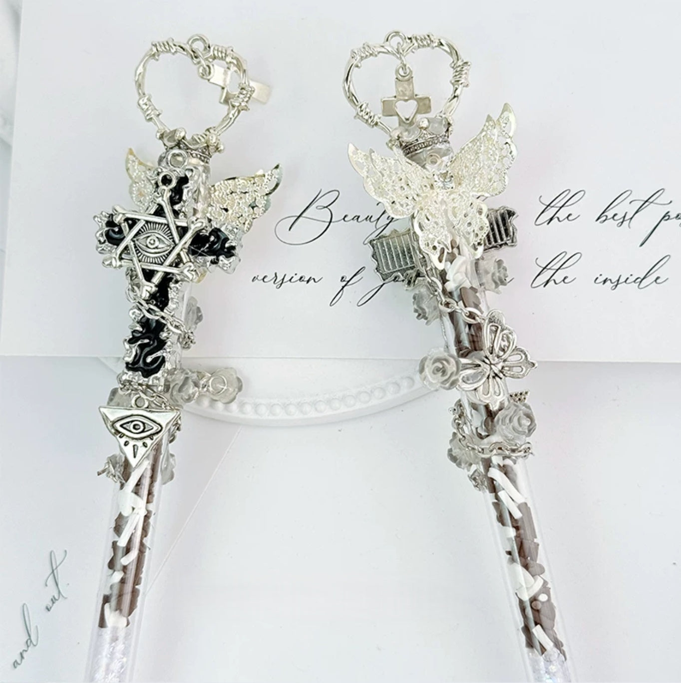 Dark gothic decorative craft knife with cross, wing, rose, chain, and red gemstone accents
