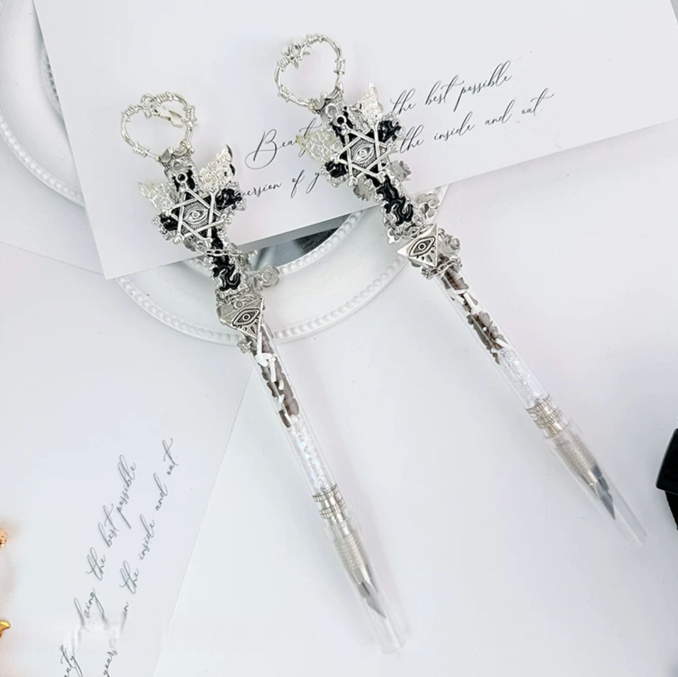 Dark gothic decorative craft knife with cross, wing, rose, chain, and red gemstone accents