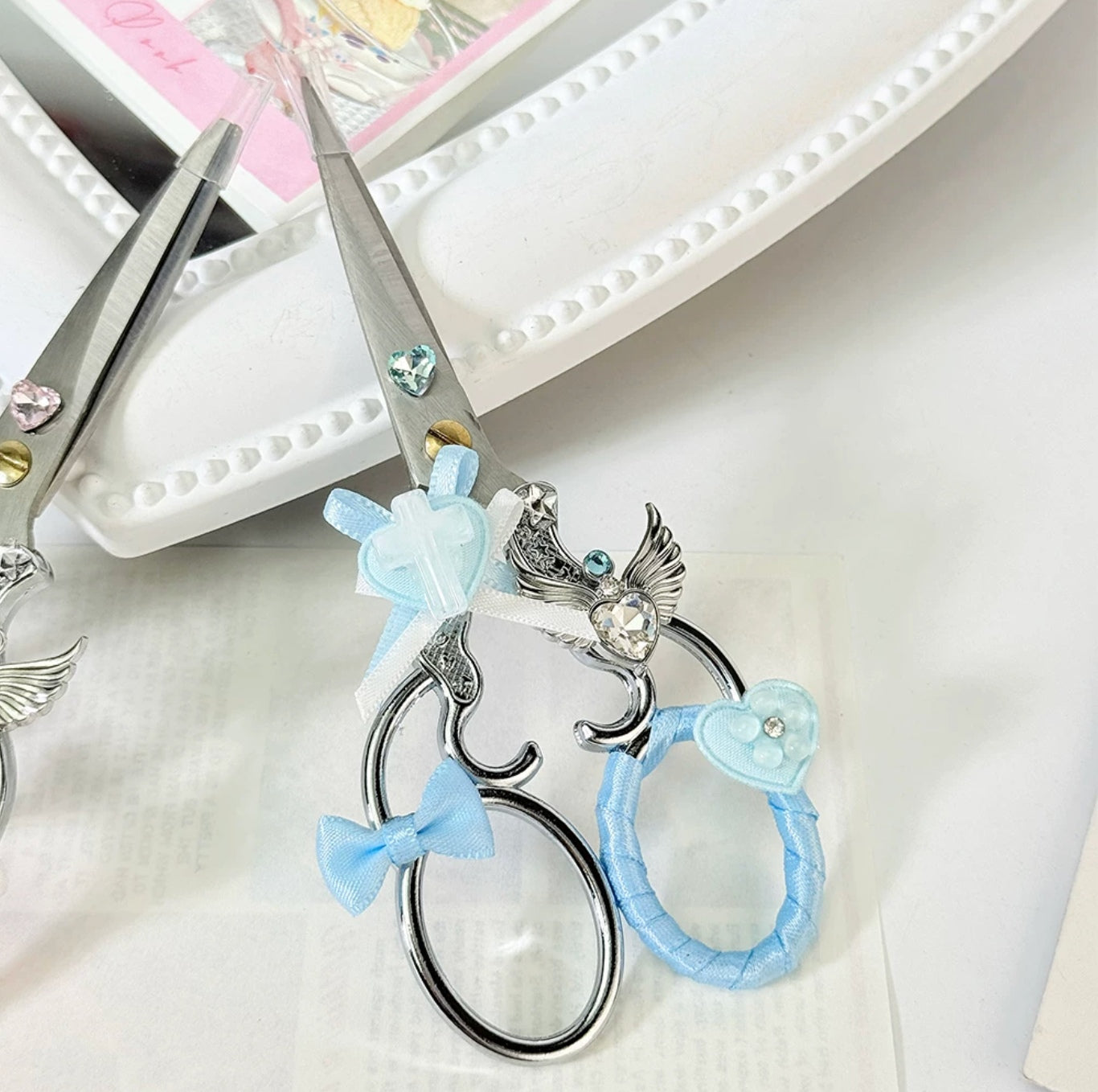 Decorative metal craft scissors with ribbon, wing, heart, and cross charms