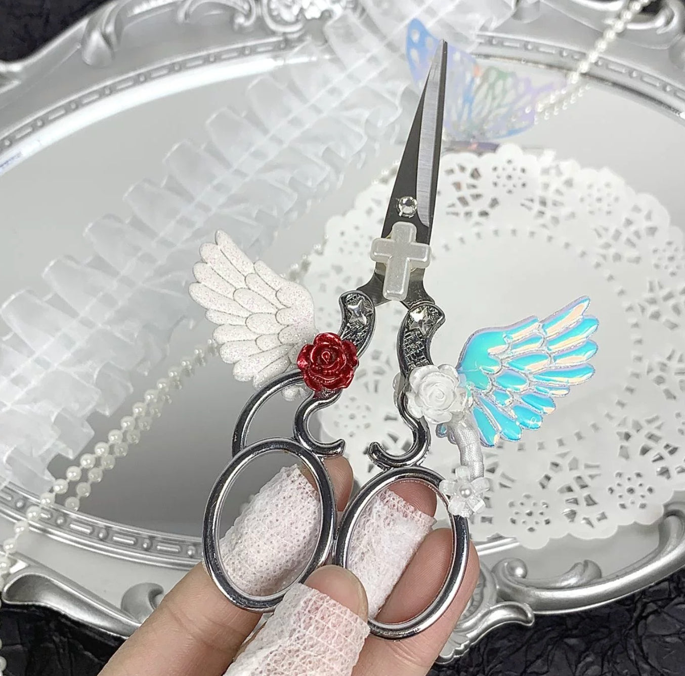 Decorative metal craft scissors with ribbon, wing, heart, and cross charms