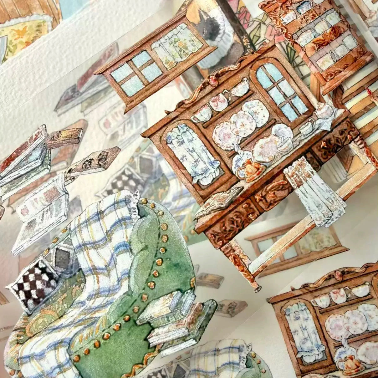 Layered cozy room PET tape pieces showing a green sofa, wooden cabinet, shelves, and books