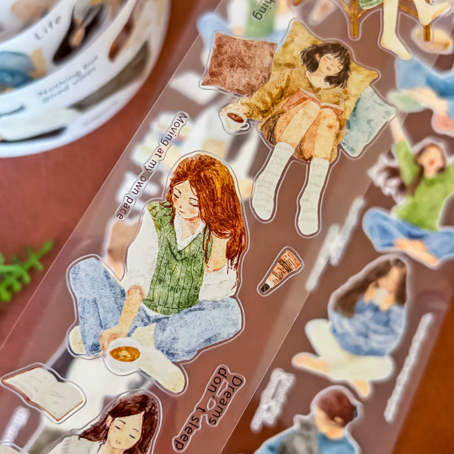 Transparent sticker roll with watercolor girls, cats, cozy reading scenes, cushions, drinks, and gentle quotes