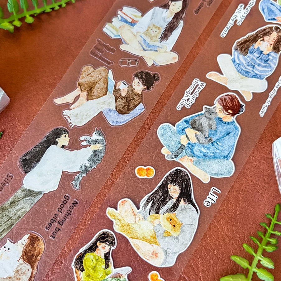 Transparent sticker roll with watercolor girls, cats, cozy reading scenes, cushions, drinks, and gentle quotes