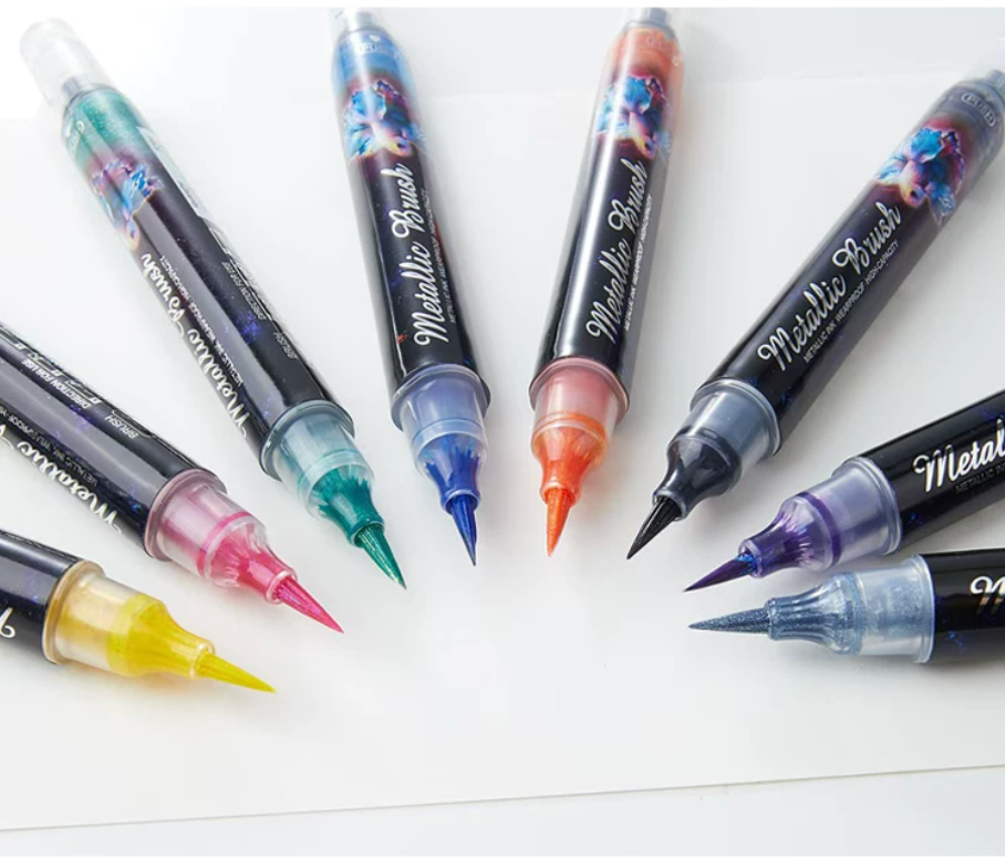 Metallic brush highlighter pen with shimmer ink, colored cap, and brush tip for lettering and notes