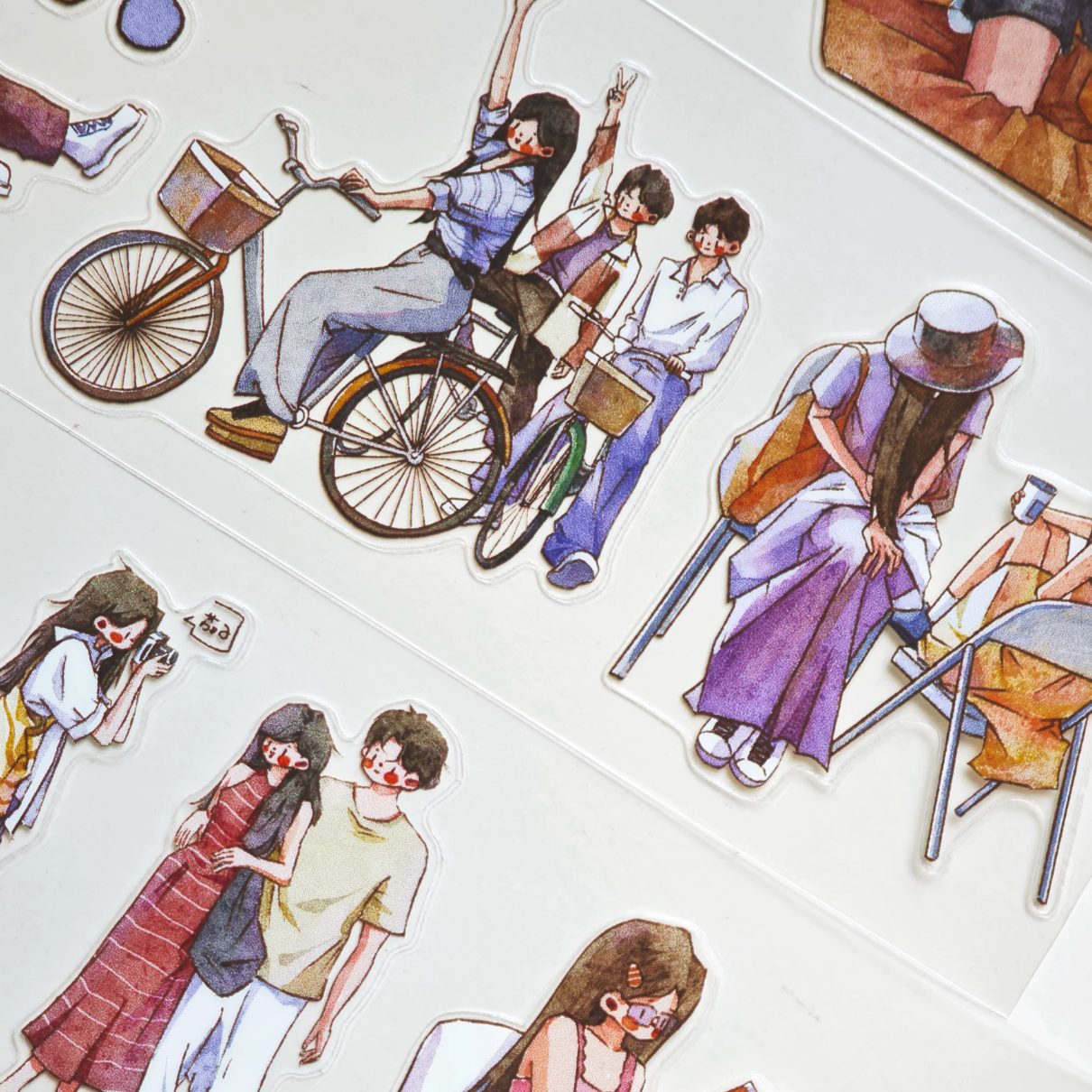 Little Moments character tape close-up with bicycle riders, standing friends, and warm lifestyle figures