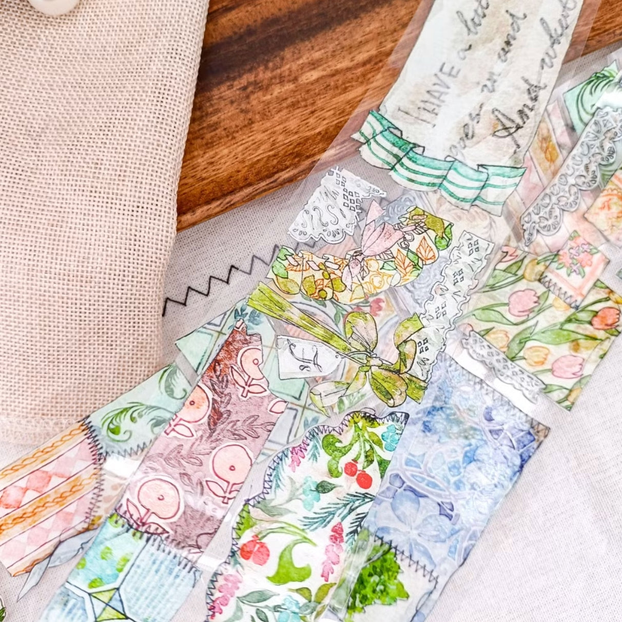 Patchwork countryside scenes, flowers, and vintage labels on PET tape