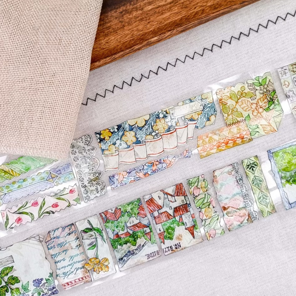 Patchwork countryside scenes, flowers, and vintage labels on PET tape