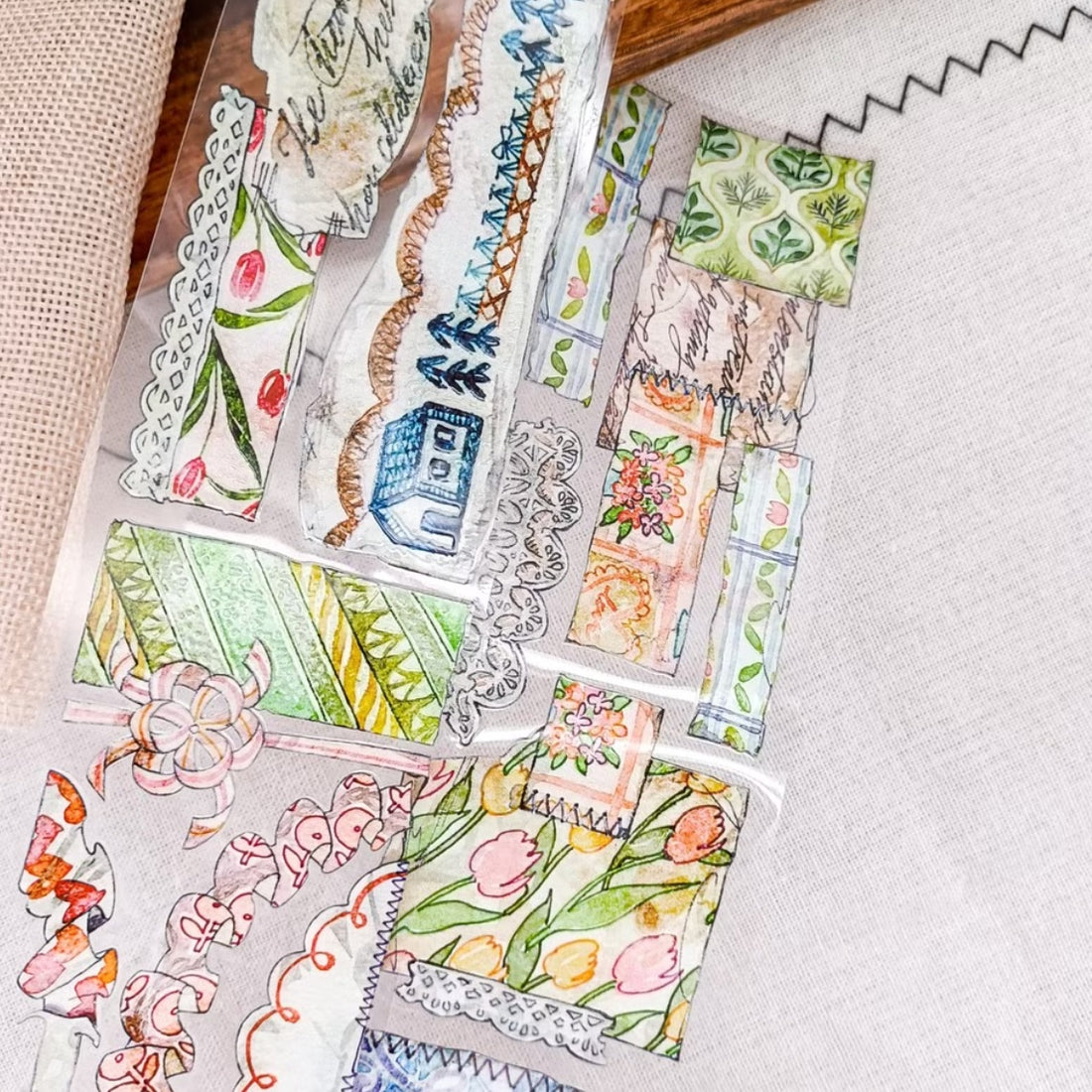 Patchwork countryside scenes, flowers, and vintage labels on PET tape