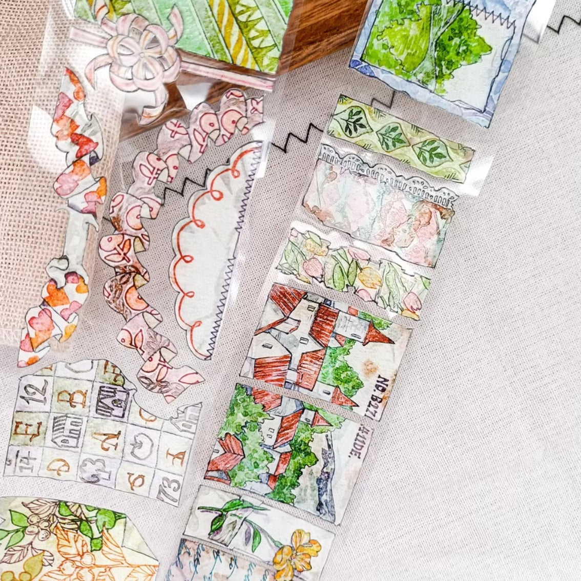 Patchwork countryside scenes, flowers, and vintage labels on PET tape