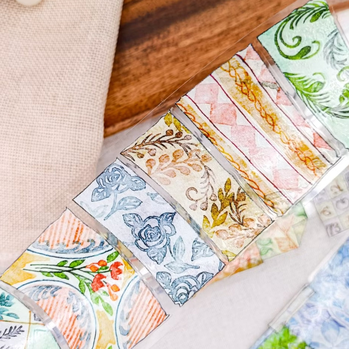 Patchwork countryside scenes, flowers, and vintage labels on PET tape
