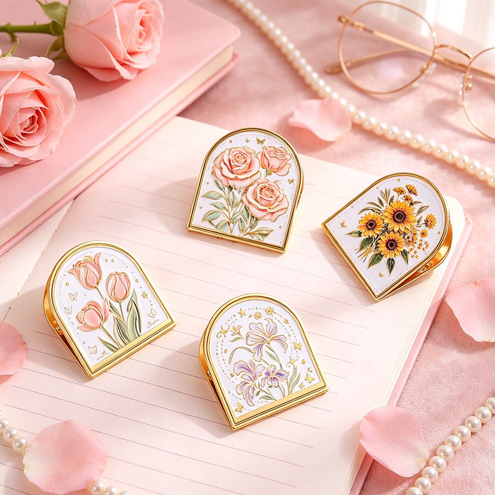 Gold-trim enamel journal clips with embossed floral designs styled with roses and pearls
