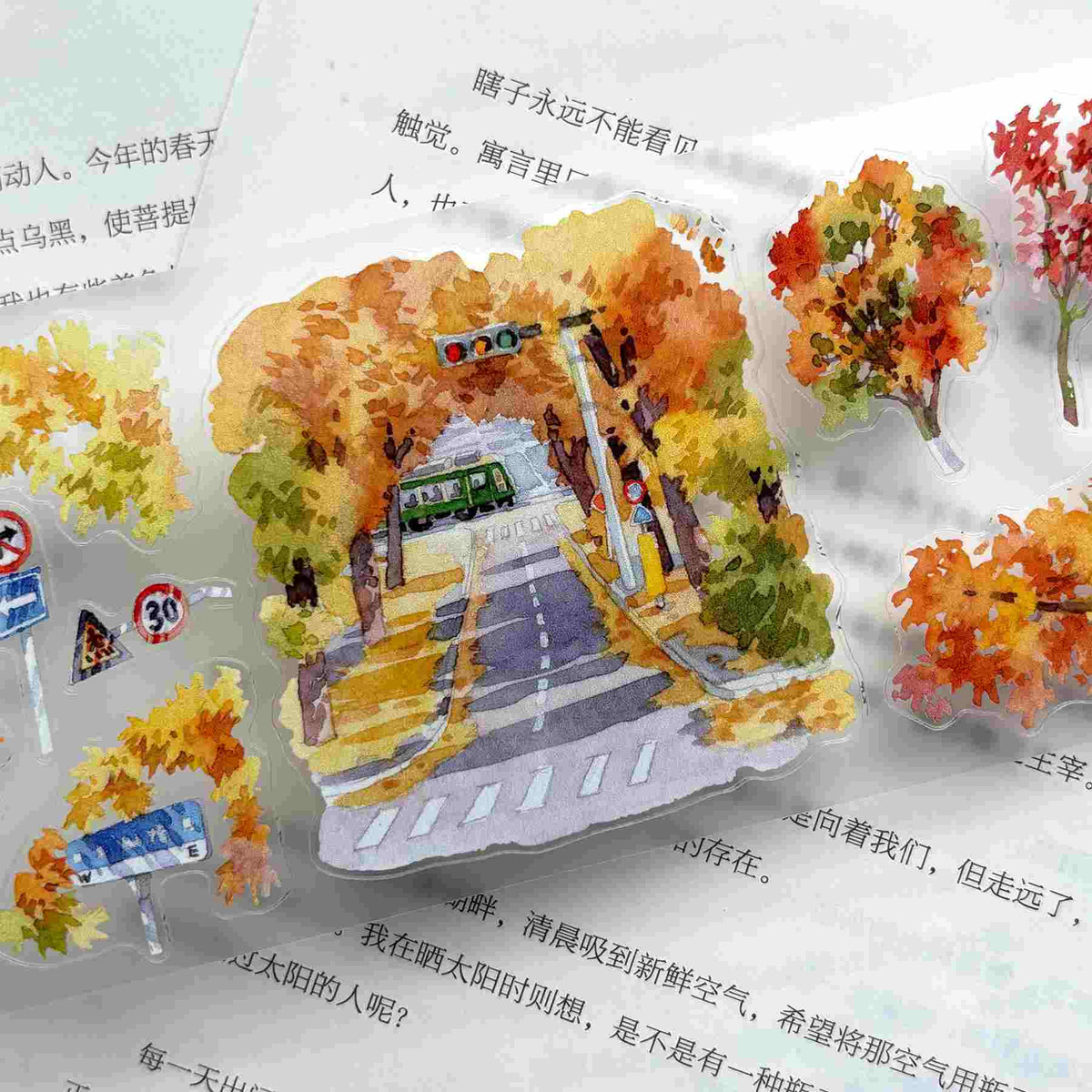 Die-cut washi tape featuring a golden ginkgo-lined street scene with houses and a canal
