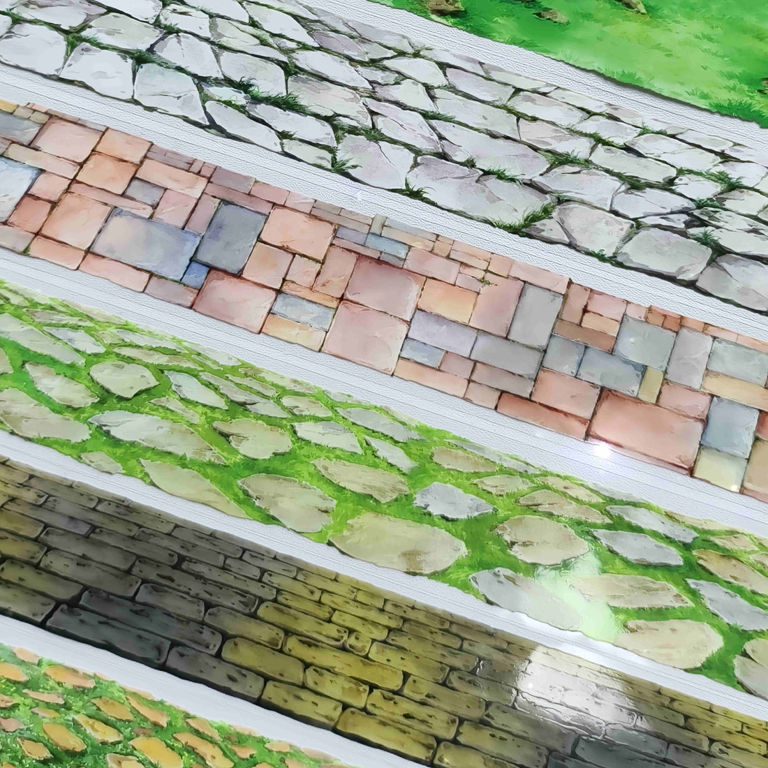 Ground Scenery PET Tape Collection – four pavement designs shown together: pale stone pavers, mixed brick and stone tiles, mossy cobblestones with grass, and a stacked stone wall