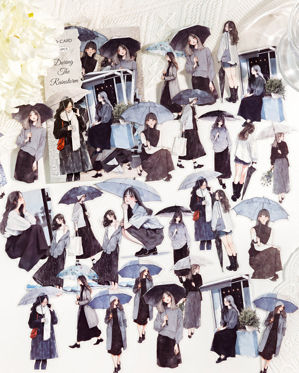 Die-cut sticker sheet of illustrated girls holding umbrellas in the rain, "During the Rainstorm" pack