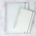 Colorful washi tape storage album with clear pocket pages for organizing pre-cut tape pieces and stickers neatly.