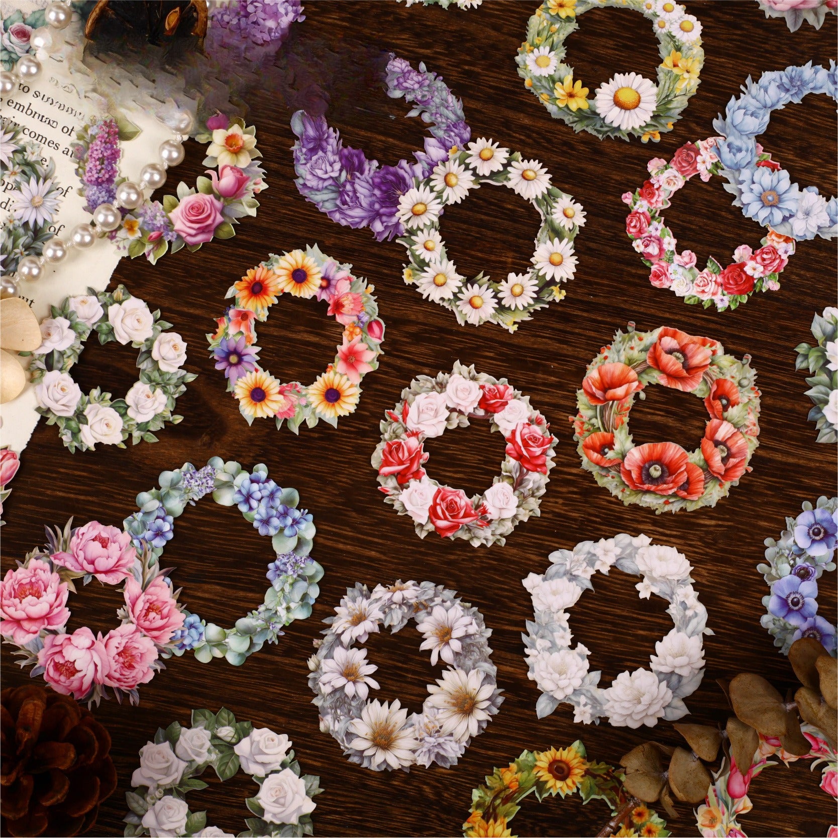 Assorted vintage floral wreath cardstock stickers arranged on a dark tabletop