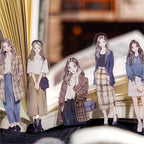 Five clear decorative anime girl stickers in trendy outfits, standing in an open journal, from Shroomi.