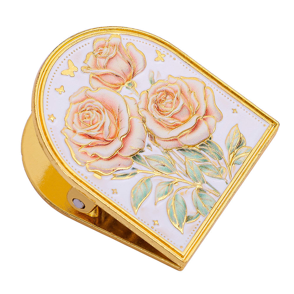 Close-up of the rose-design embossed gold-tone metal journal clip