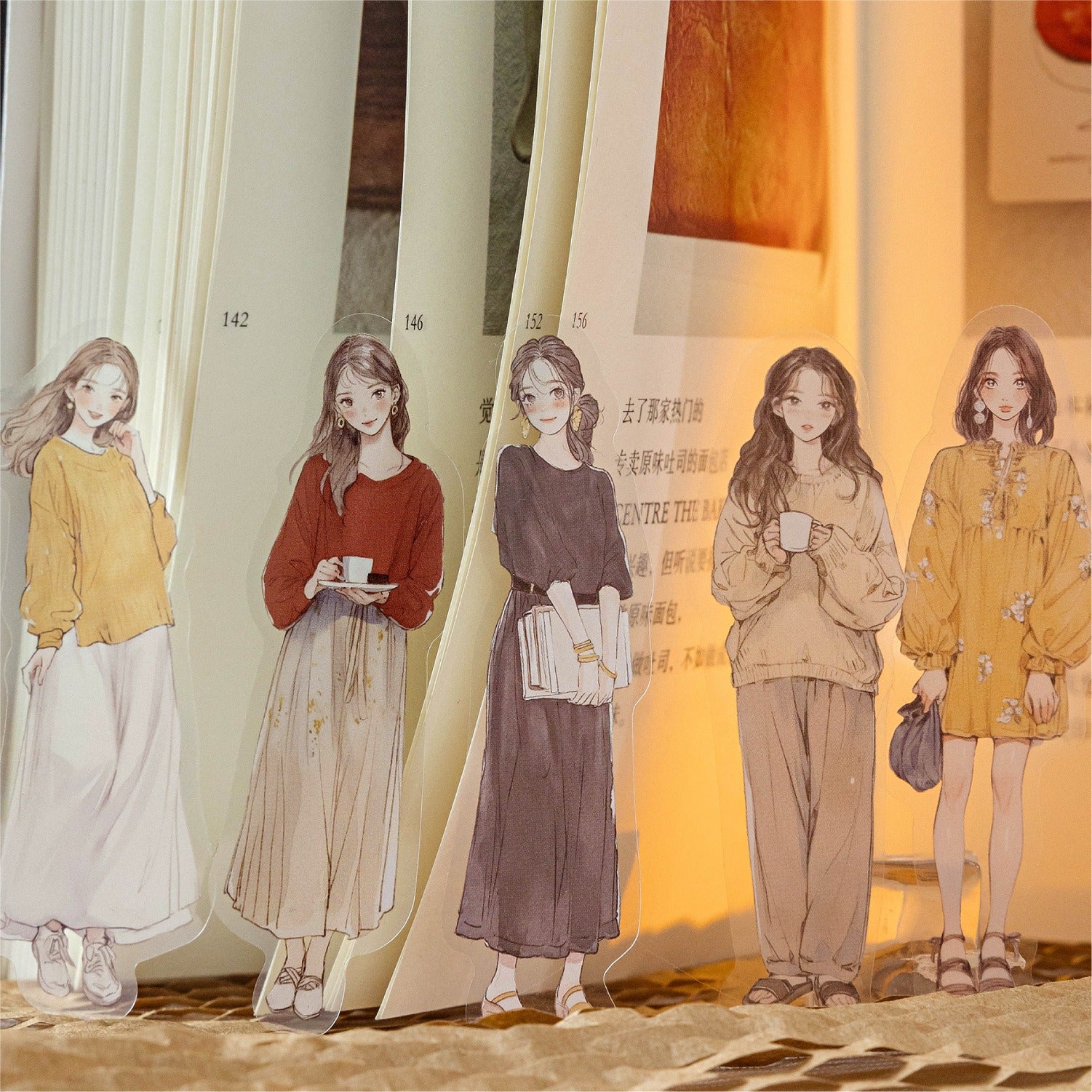 Illustrated transparent girl bookmarks and stickers posed within a book, adding aesthetic charm to your Shroomi journaling.