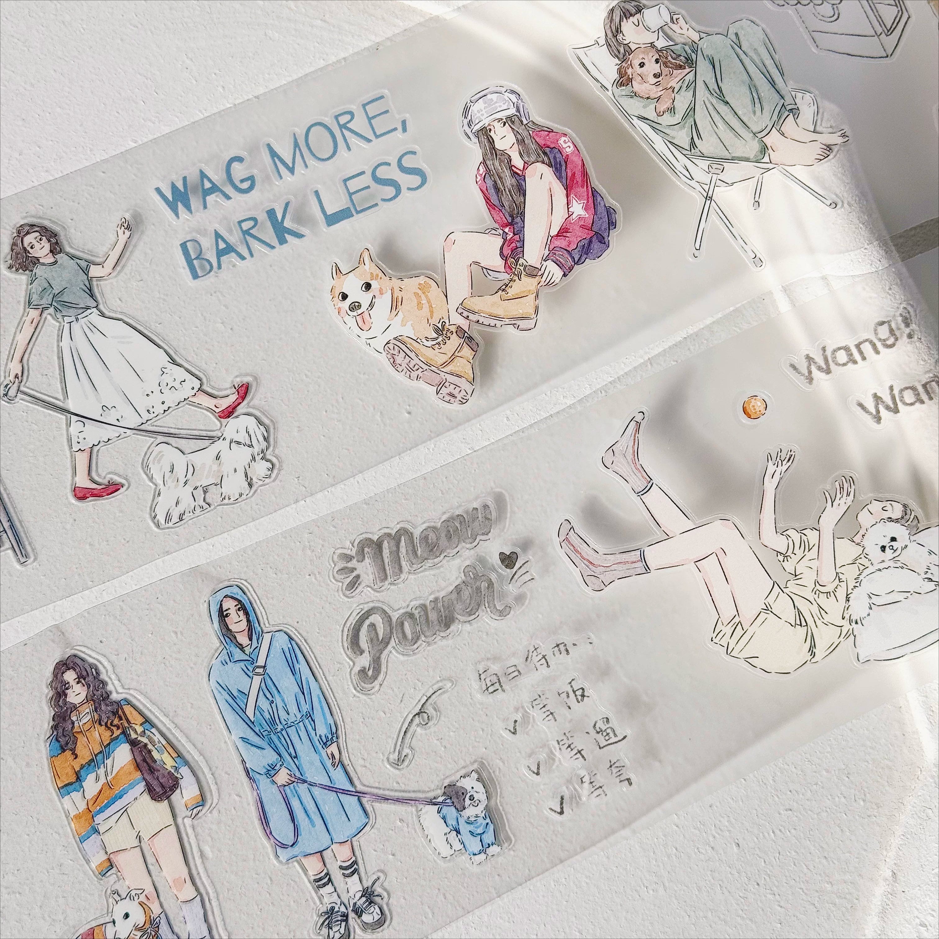 Happy Moment Pets die-cut tape close-up with dog, seated girl, and wag more text