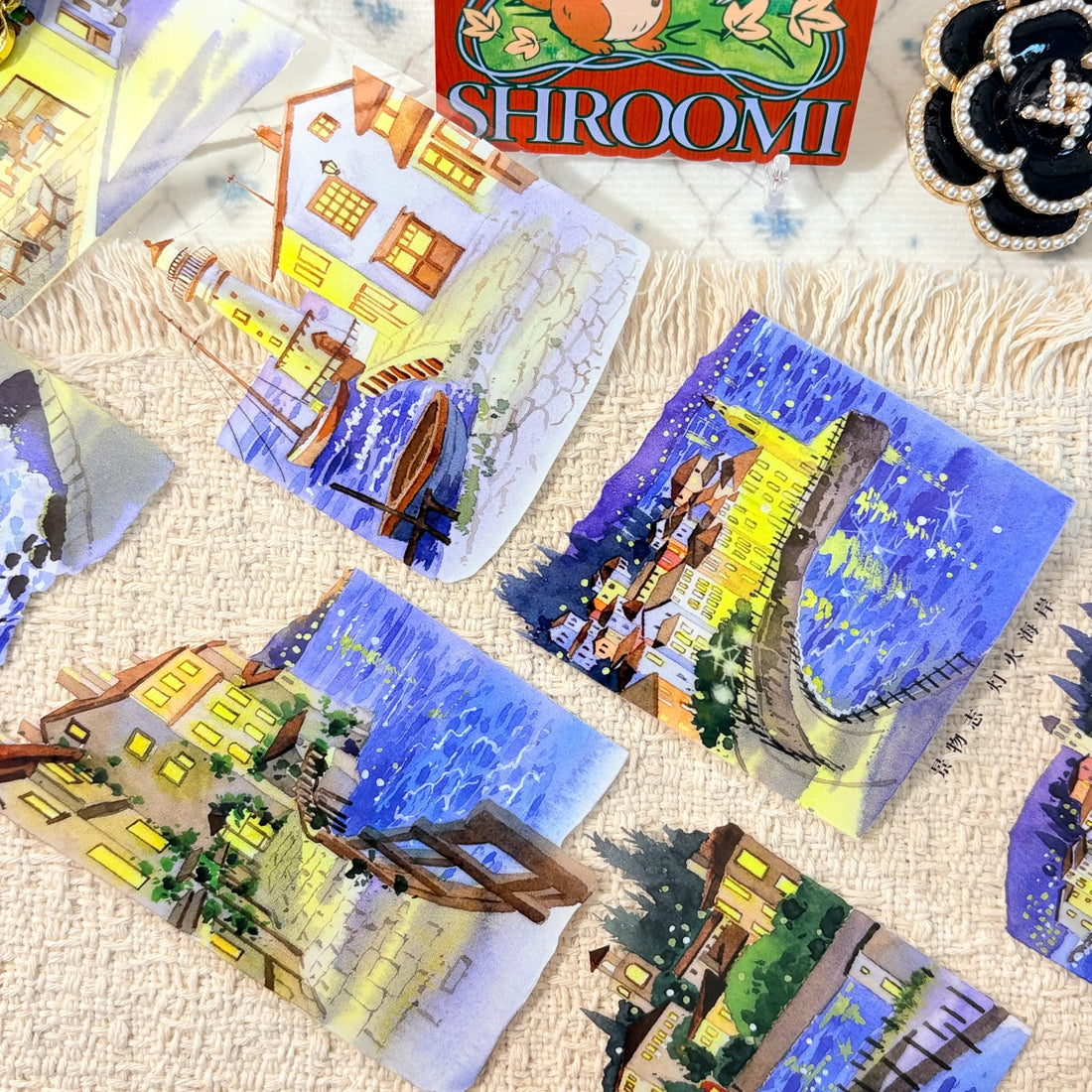 Glowing waterfront buildings in deep blue evening scenes on decorative tape