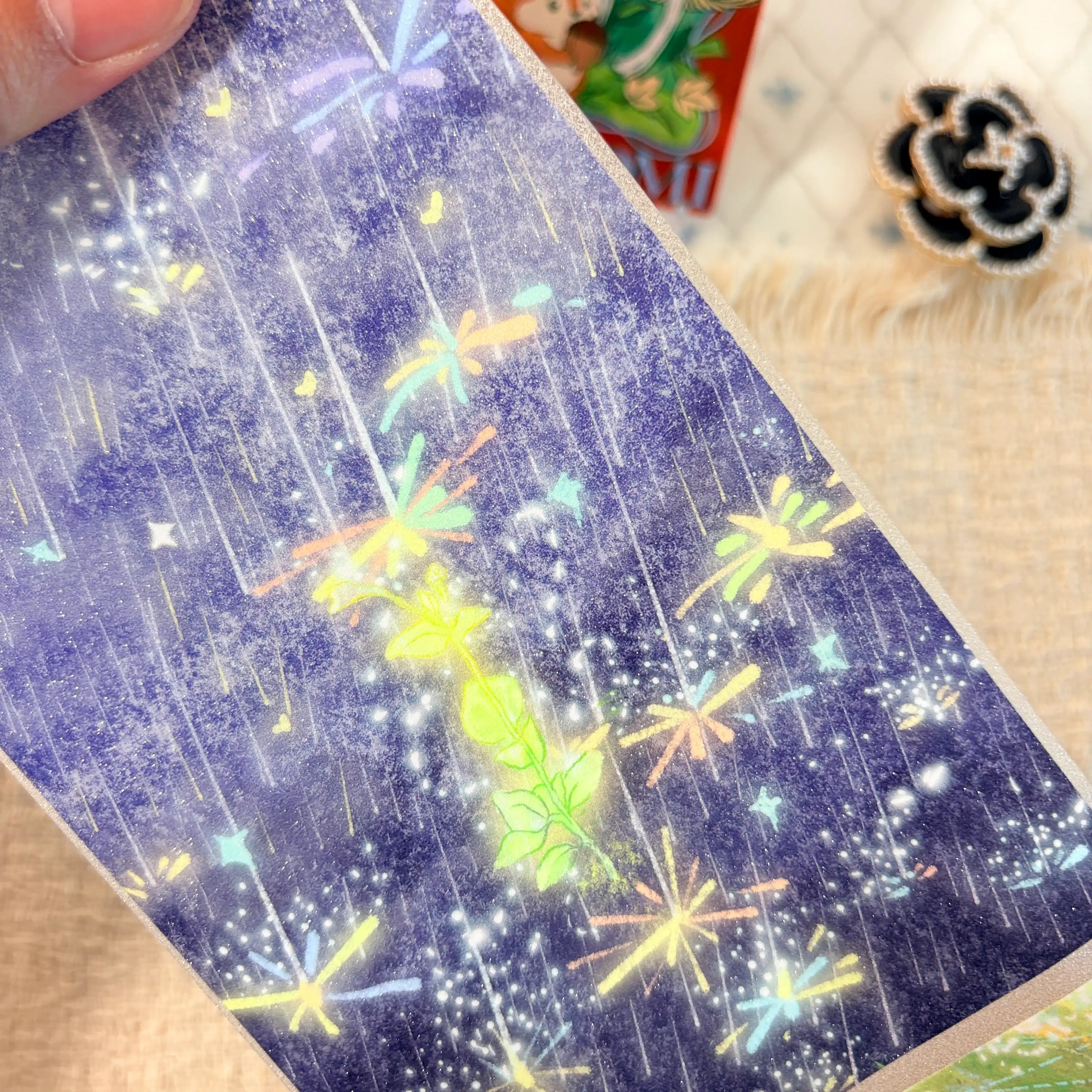 Colorful fireworks and glowing stars across a deep night sky on decorative tape