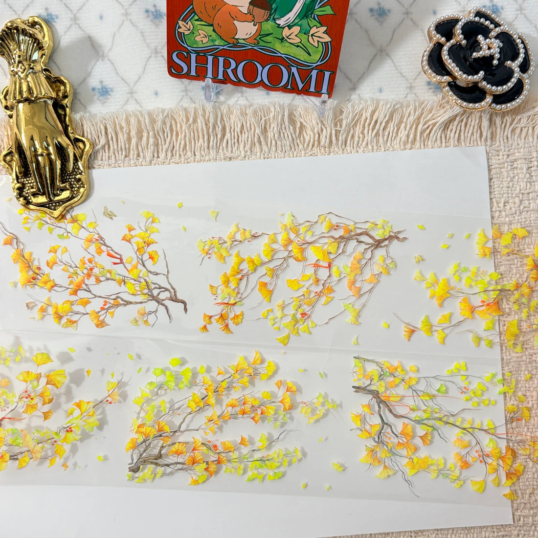Golden ginkgo branches and drifting autumn leaves on decorative tape