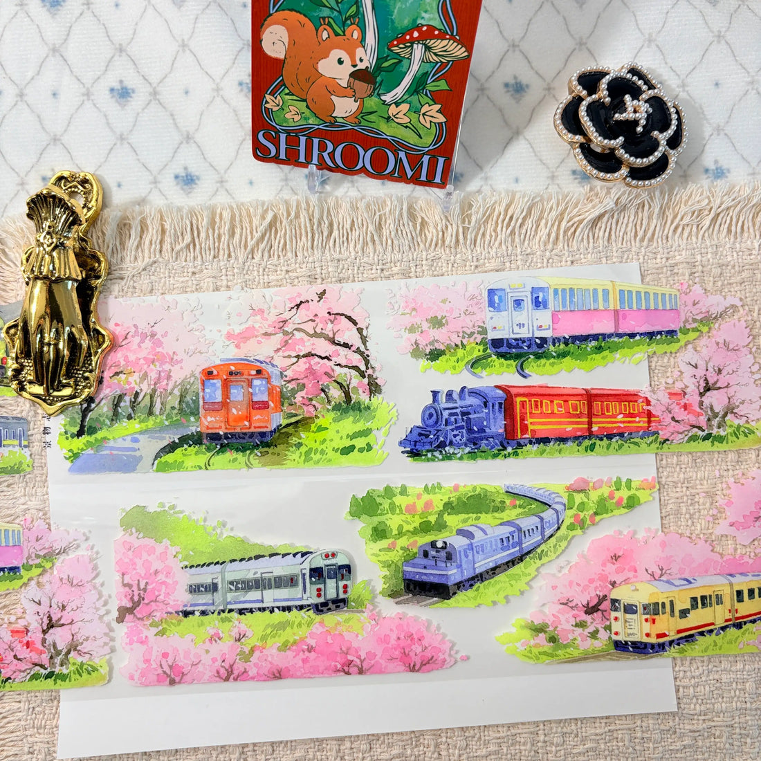 Colorful trains moving through spring blossoms and green countryside on decorative tape
