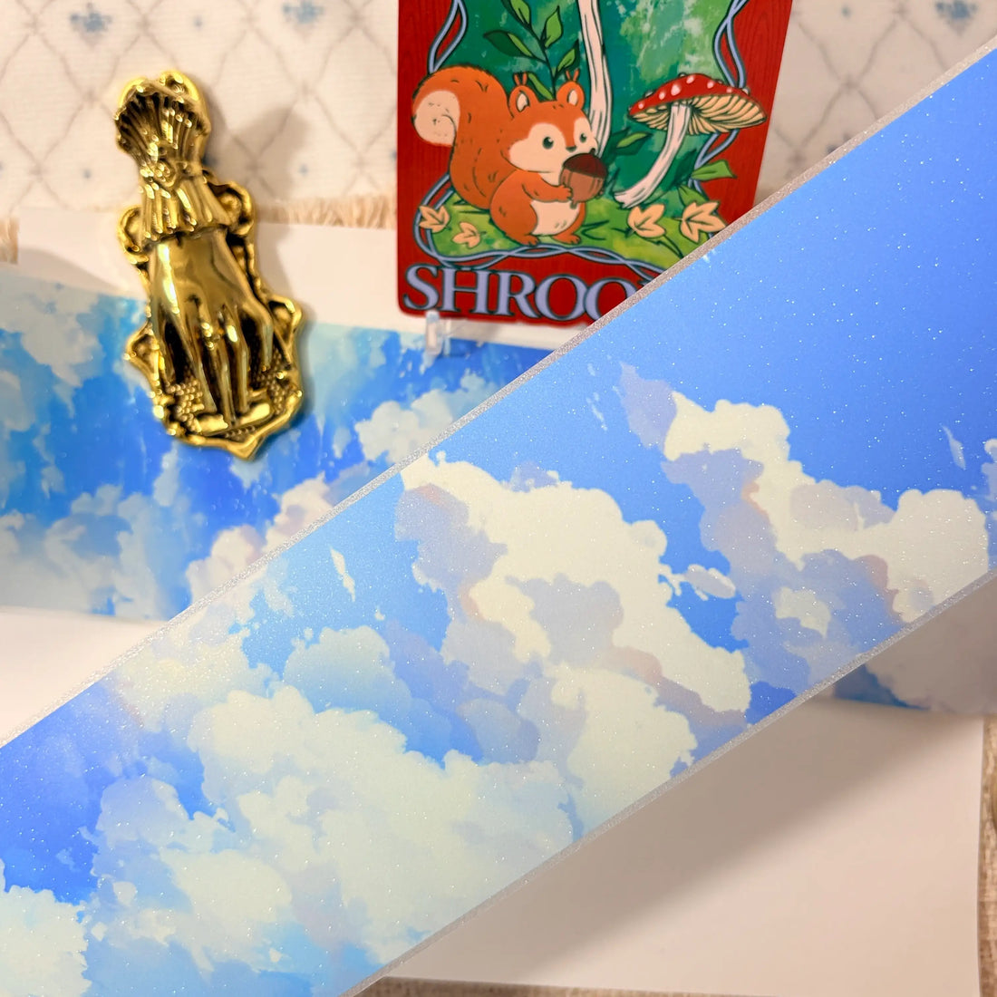 Soft blue clouds, a subtle rainbow, and starry shimmer on decorative tape