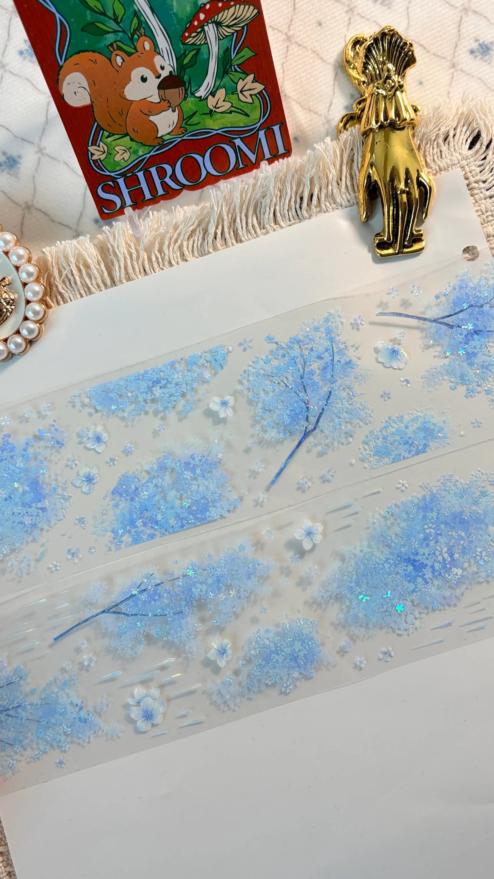Blue floral border with blossoms, butterflies, and rain-like accents on transparent PET tape