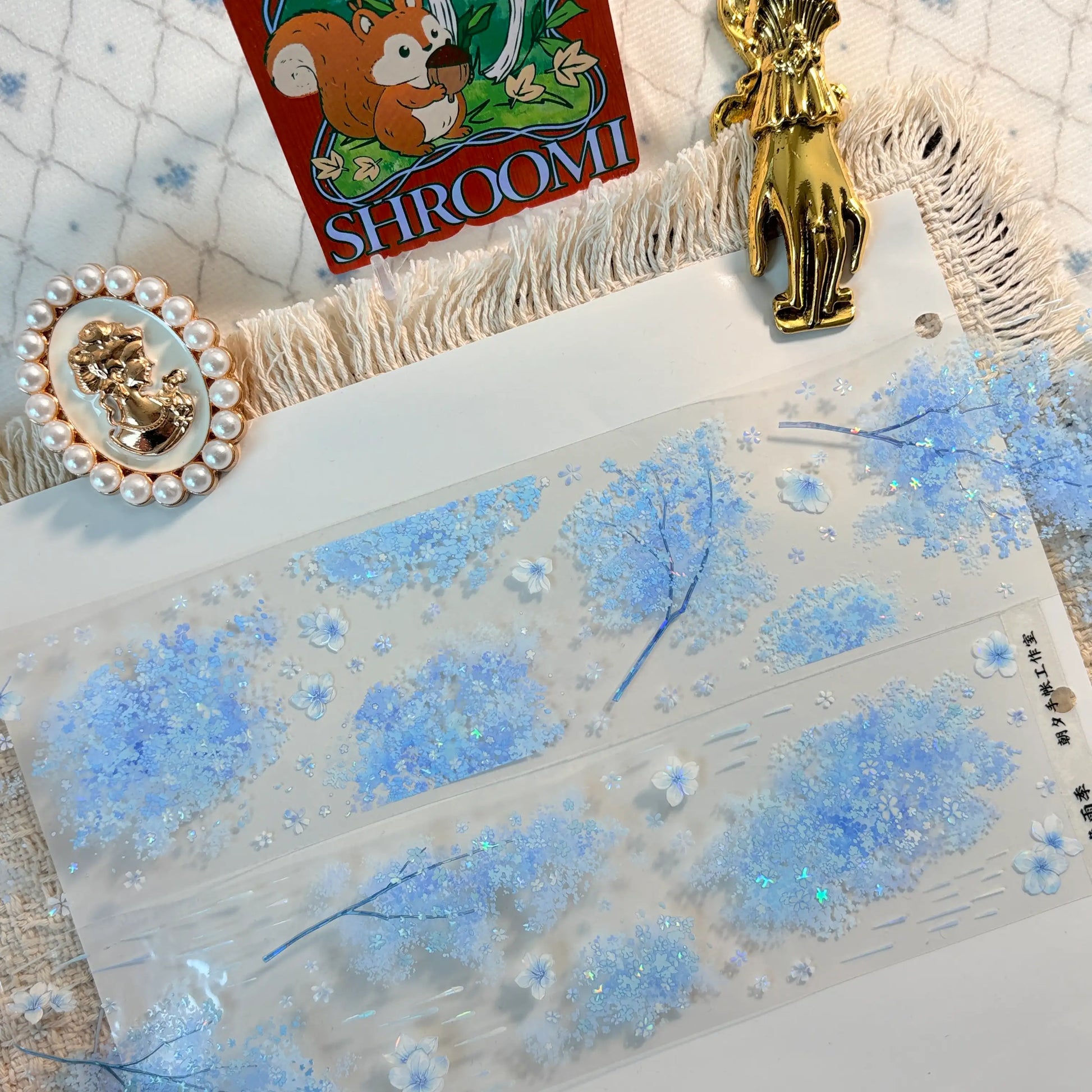 Blue floral border with blossoms, butterflies, and rain-like accents on transparent PET tape