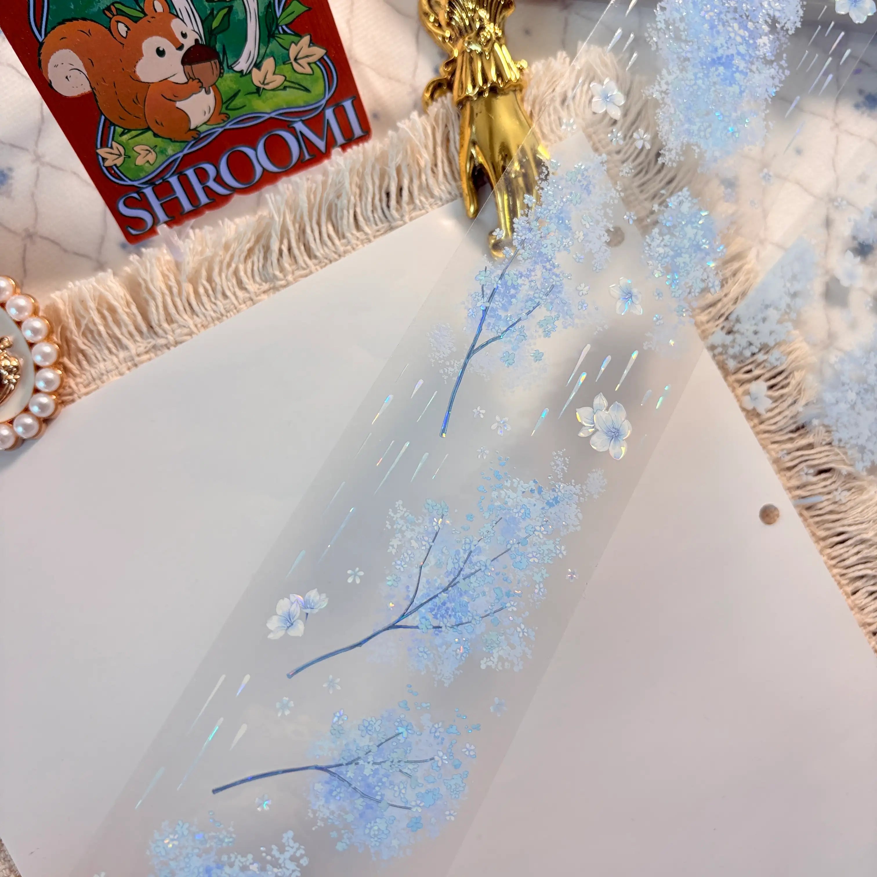 Blue floral border with blossoms, butterflies, and rain-like accents on transparent PET tape