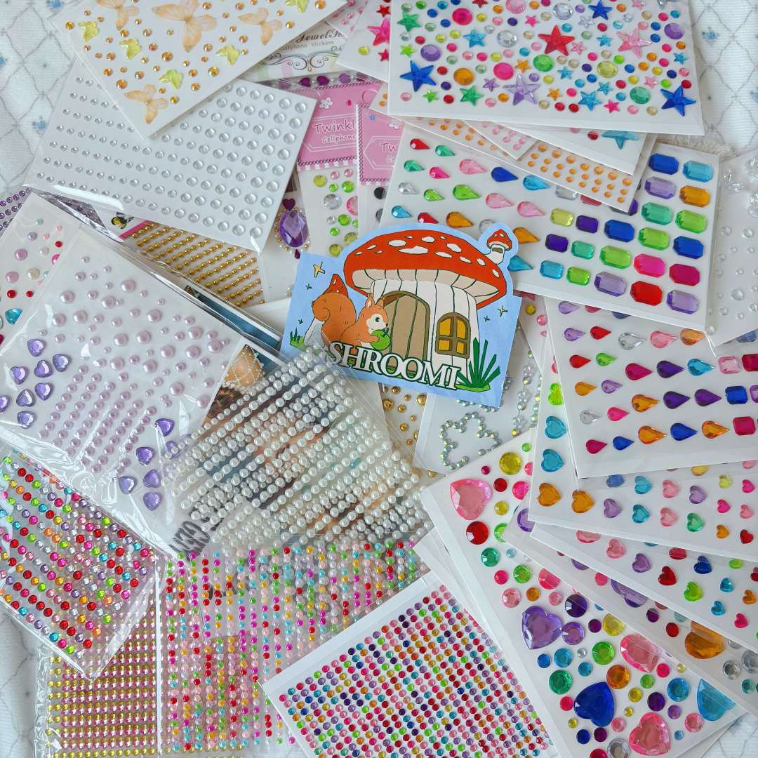 Pile of colorful gem, heart and pearl rhinestone sticker sheets
