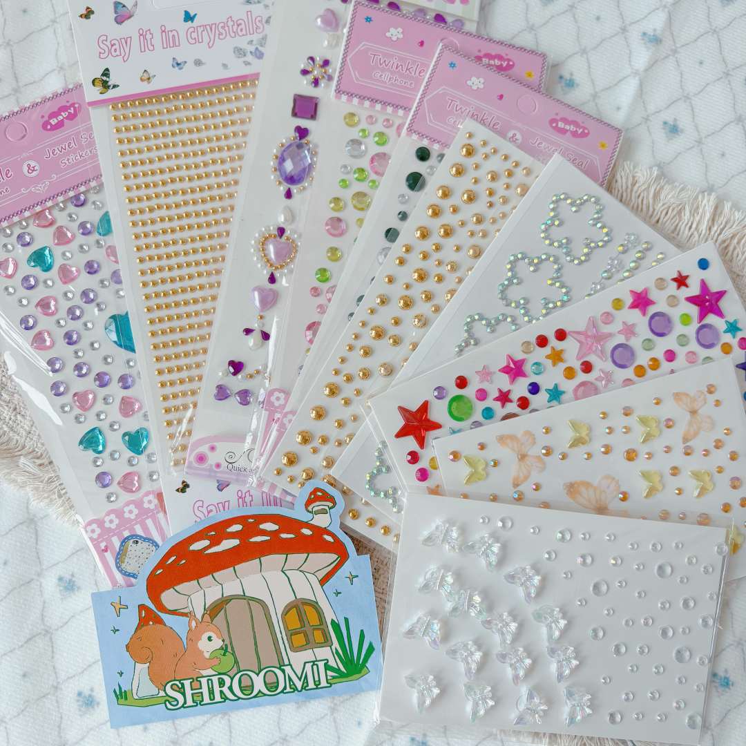 Fan of assorted rhinestone and pearl sticker sheets with Shroomi card