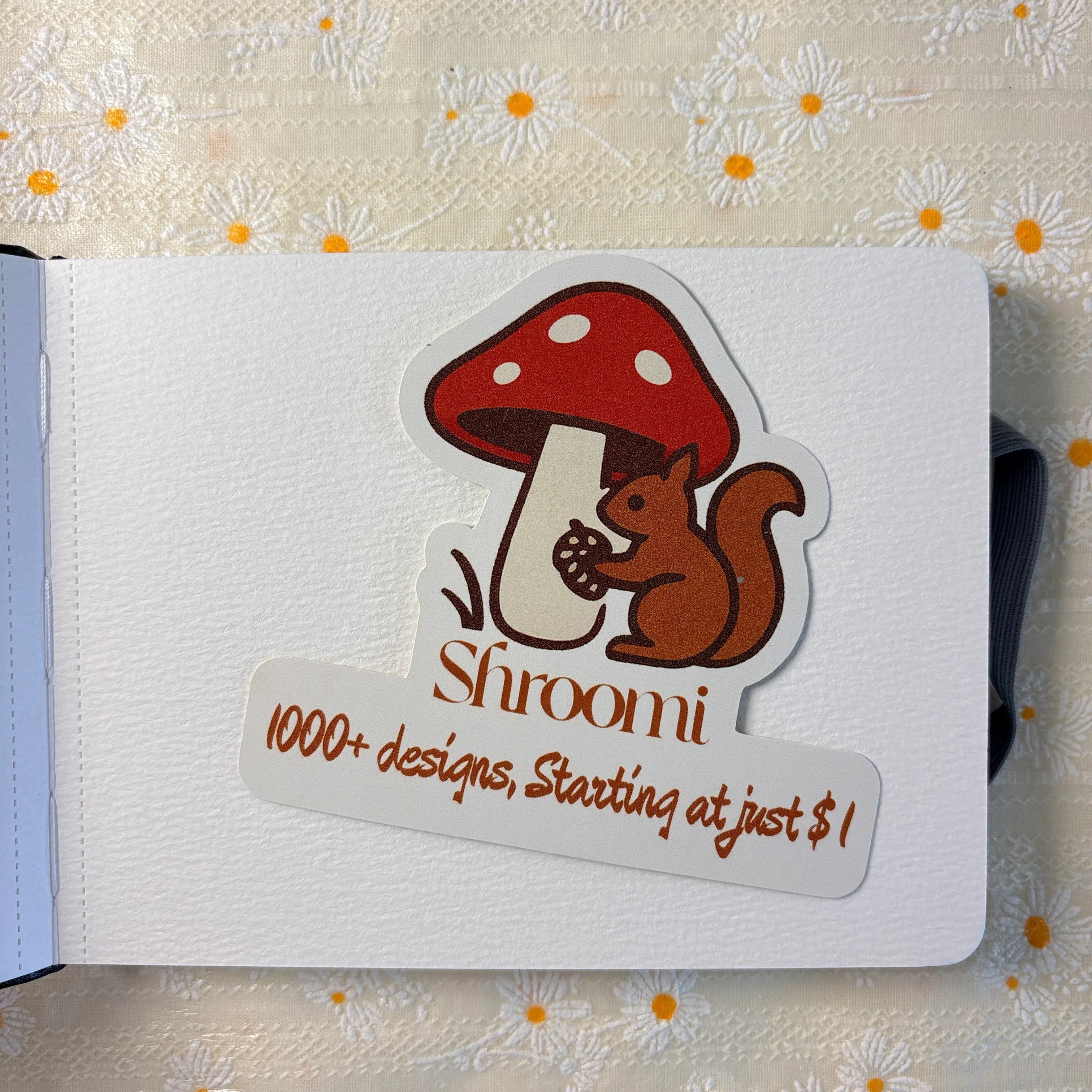 Black hardcover journal notebook with Shroomi branded mushroom squirrel sticker card