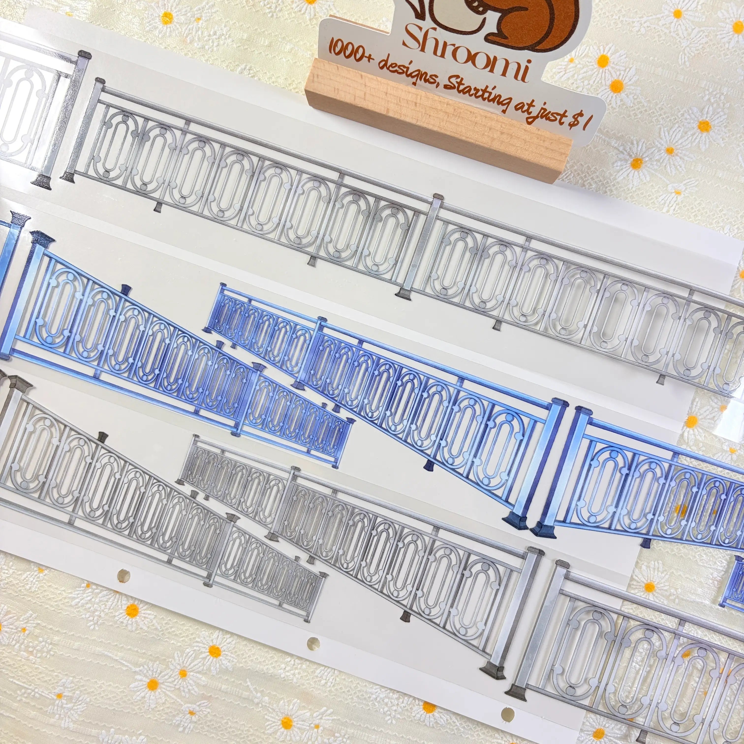 Modern ornate railing PET tape close-up showing three strips of decorative metal railing in silver and blue tones