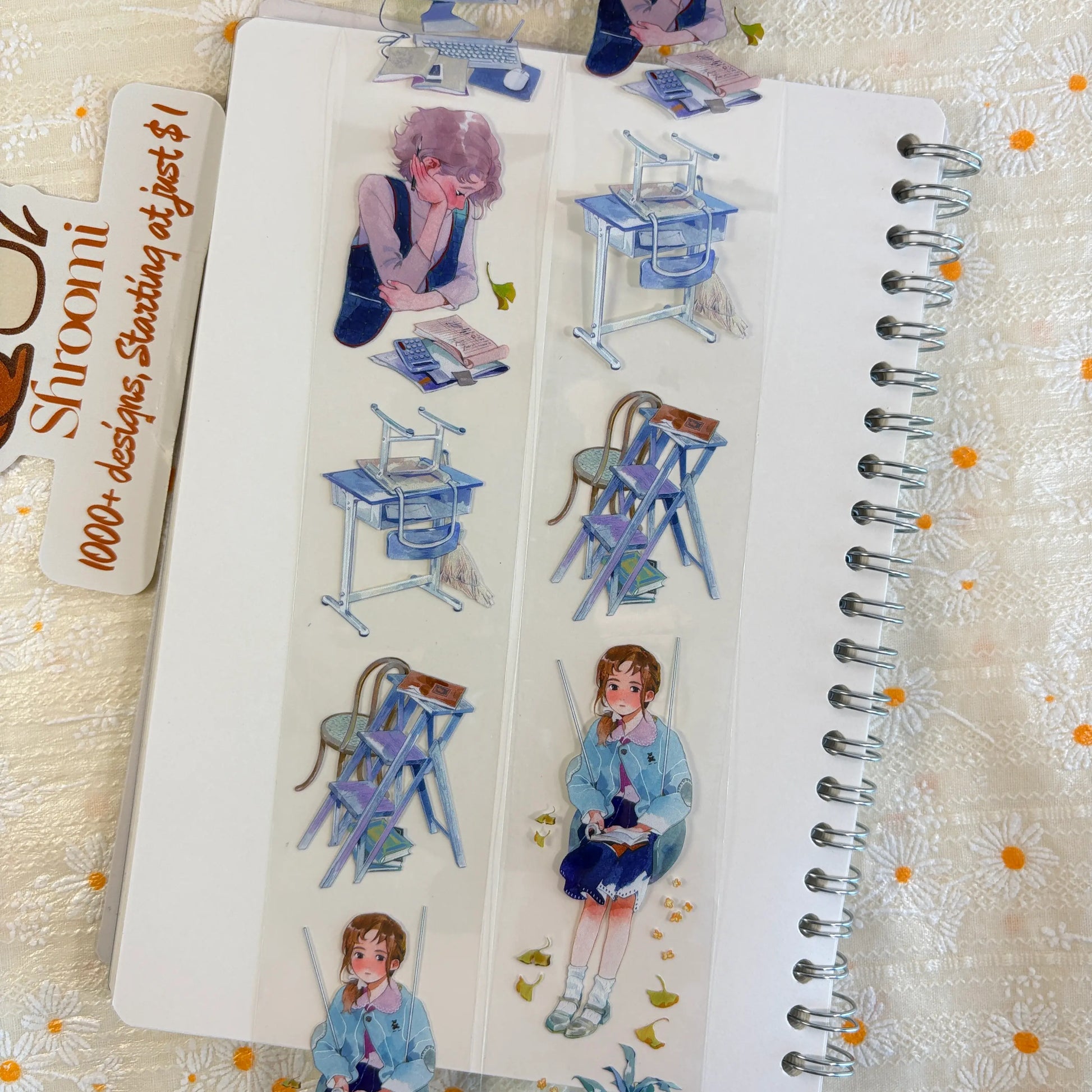 Shroomi PET tape on journal showing school life: purple-haired student studying at desk with books and calculator, stacked blue school desks, girl in blue coat sitting reading on a stool with golden ginkgo leaves