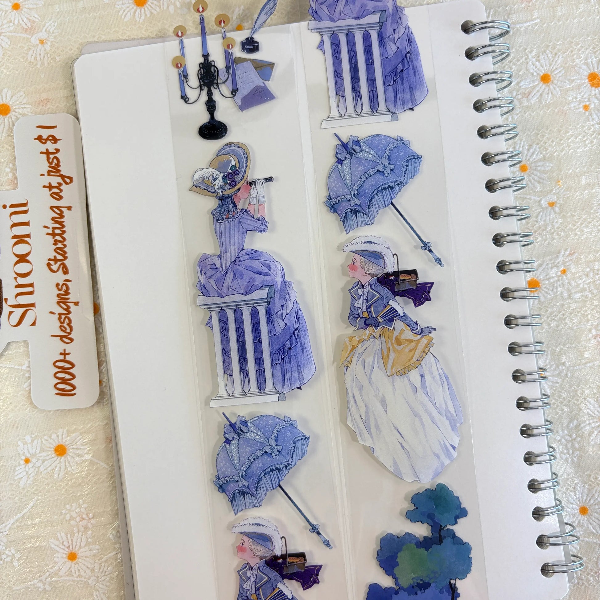 Shroomi PET tape on journal showing Rococo ball scenes: woman in elaborate lavender ballgown with plumed hat and fan, masked violinist in white, lace parasol, black candelabra with blue gem, neoclassical column