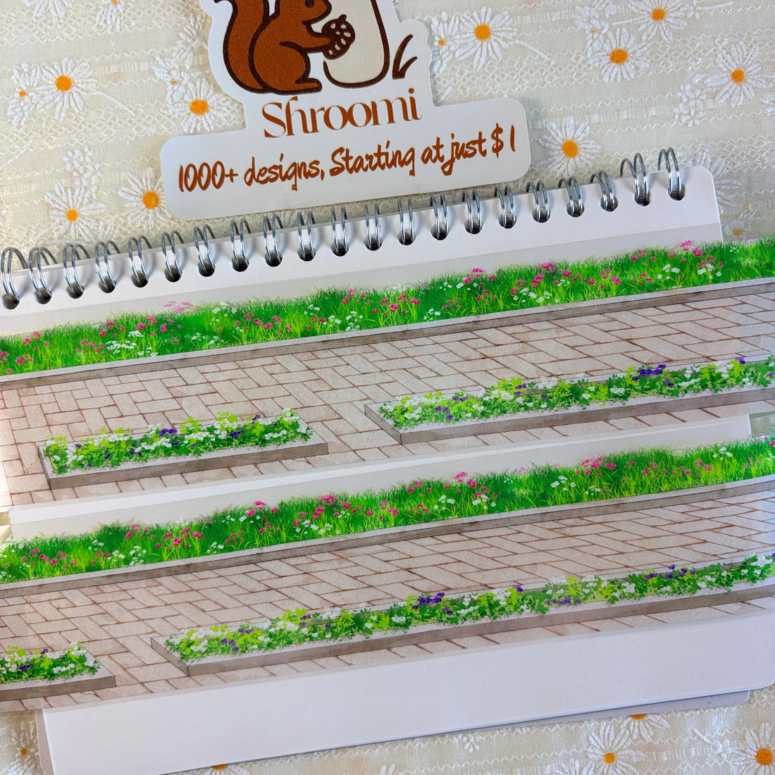 Wildflowers and green grass growing alongside stone brick sidewalk pavement on PET tape