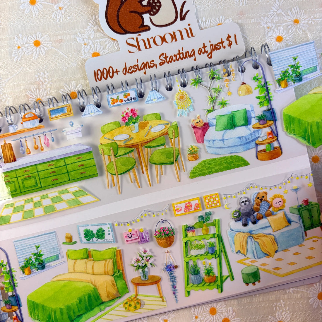 Shroomi Green Living PET tape on journal — two strips: kitchen with green cabinets, pendant lamps, and dining set (top); bedroom with yellow bed, flower vase, plant shelves, and stuffed animals on blue sofa (bottom)