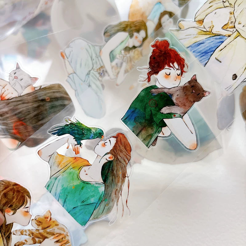 Detail of watercolor girls hugging cats and dogs illustrations on tape